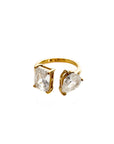 Gold ring with clear gemstones on a white background