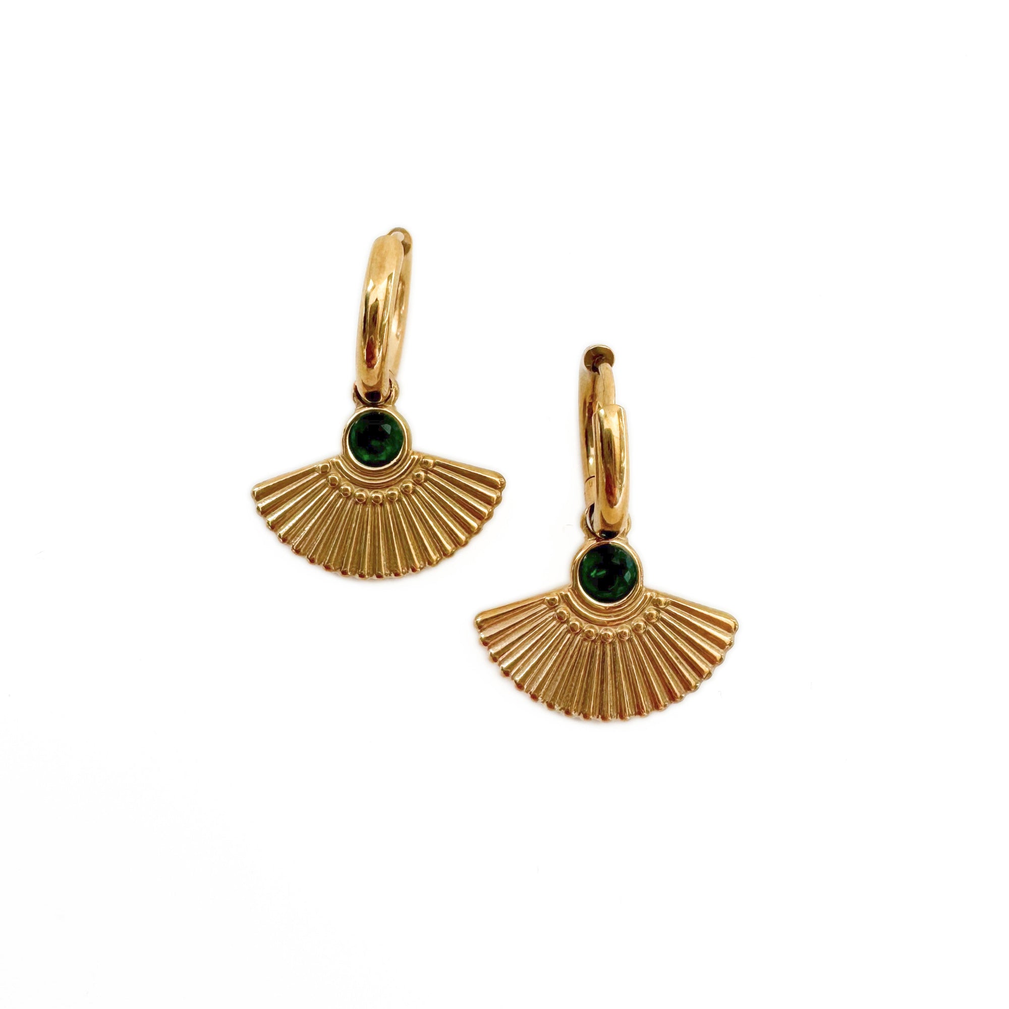 Gold fan-shaped earrings with green gemstones on a white background