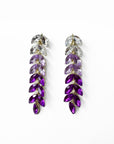 Purple and clear crystal earrings on a white background