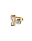Gold ring with rectangular and round gemstones on a white background