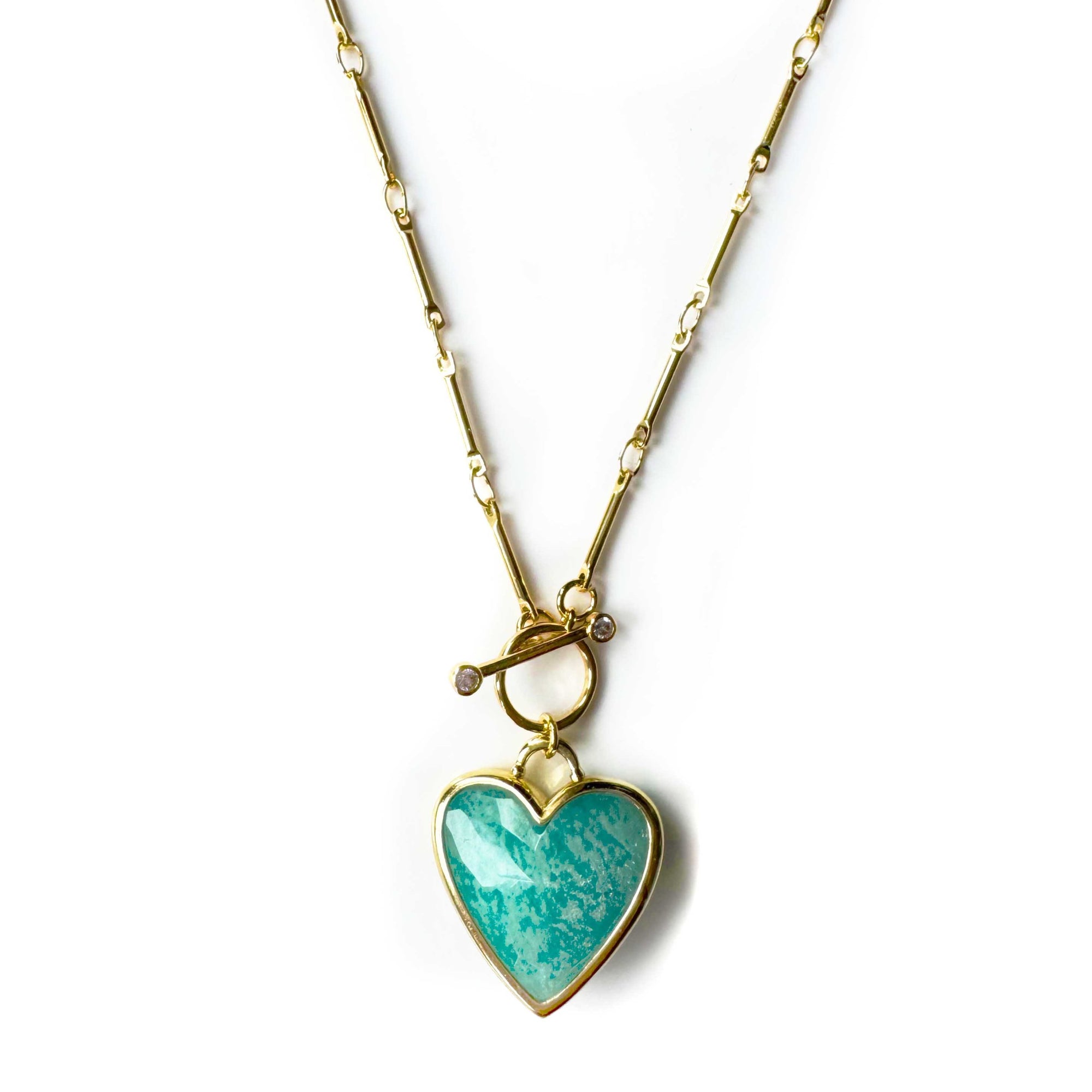 An 18k gold plated necklace with a turquoise heart-shaped pendant, displayed on a white background.