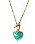 An 18k gold plated necklace with a turquoise heart-shaped pendant, displayed on a white background.