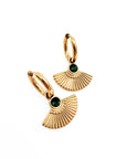 Gold earrings with green gemstones on a white background