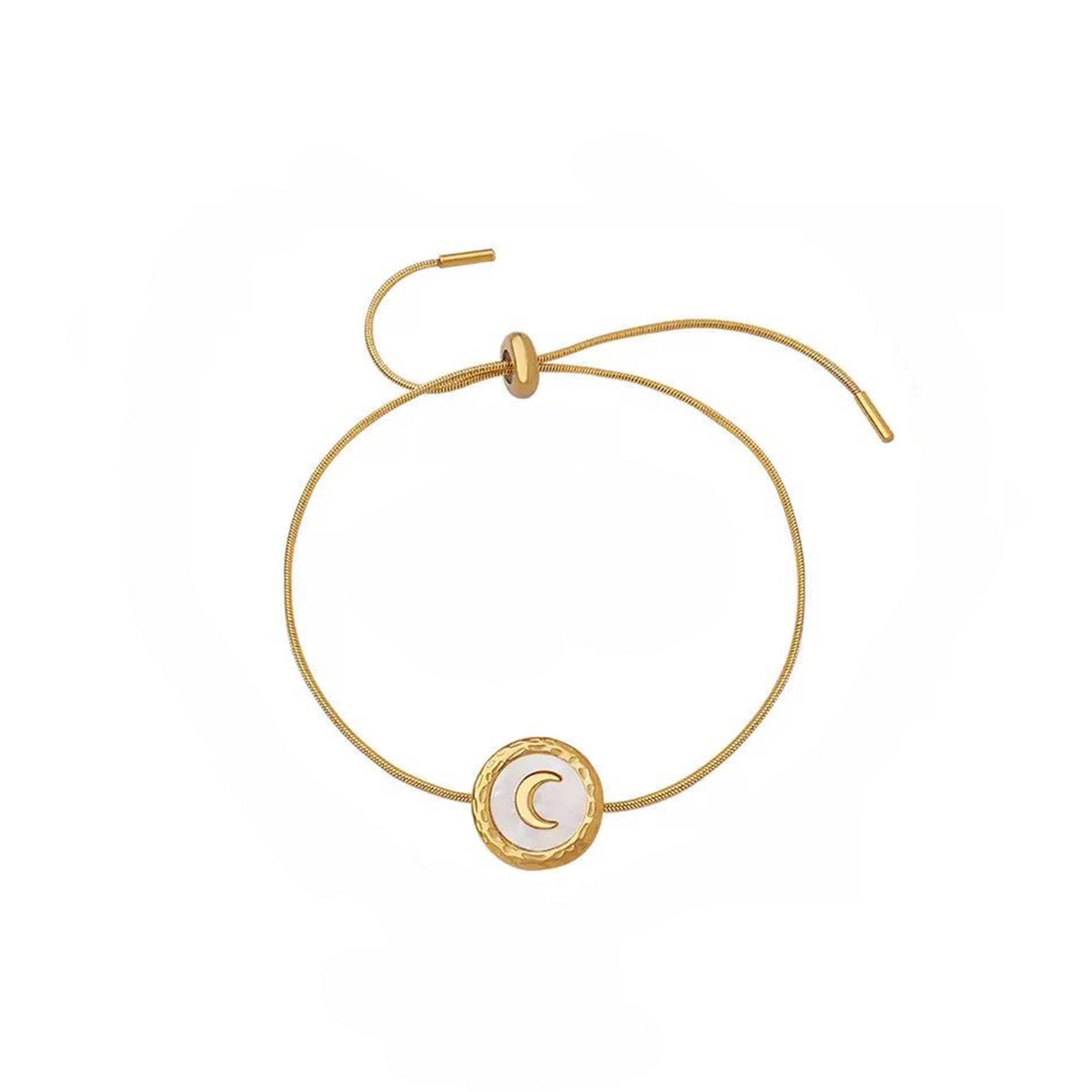 Gold bracelet with a moon symbol on a white background