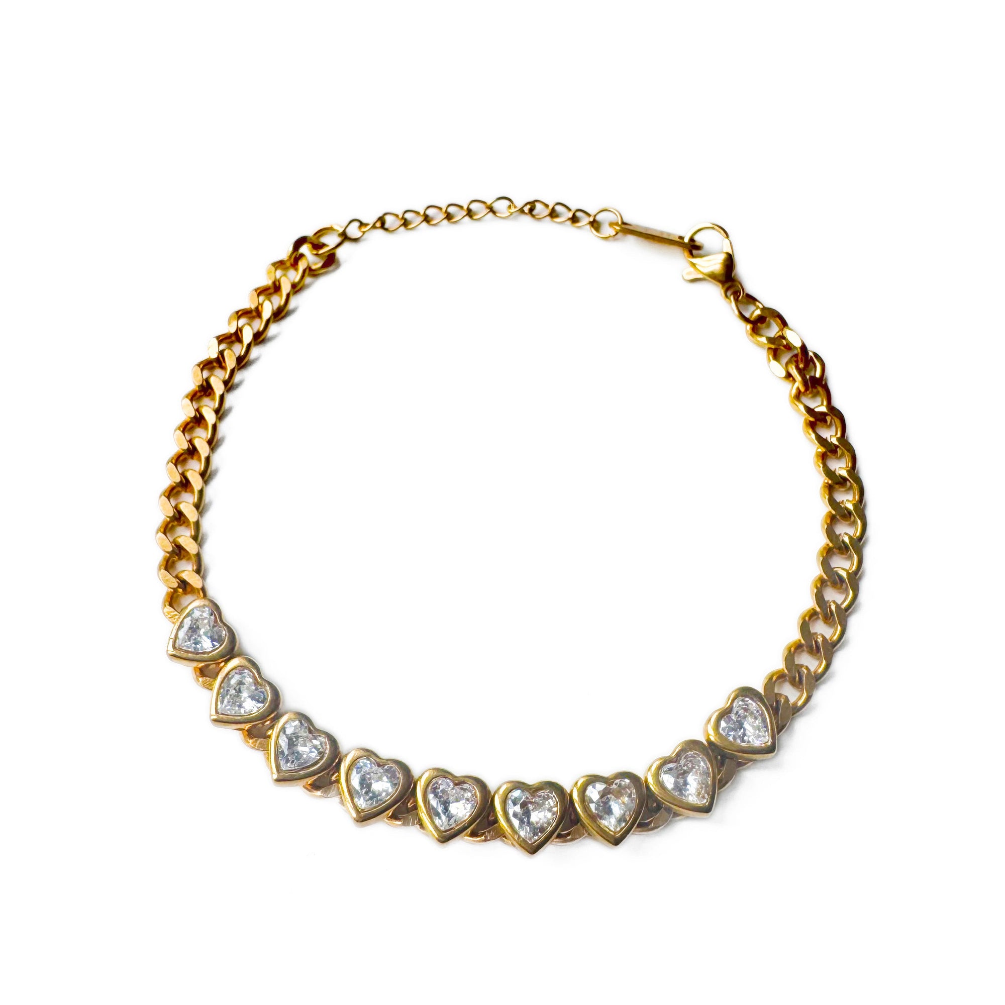 Gold necklace with heart-shaped gemstones on a white background