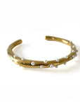 Gold bracelet with pearls on a white background