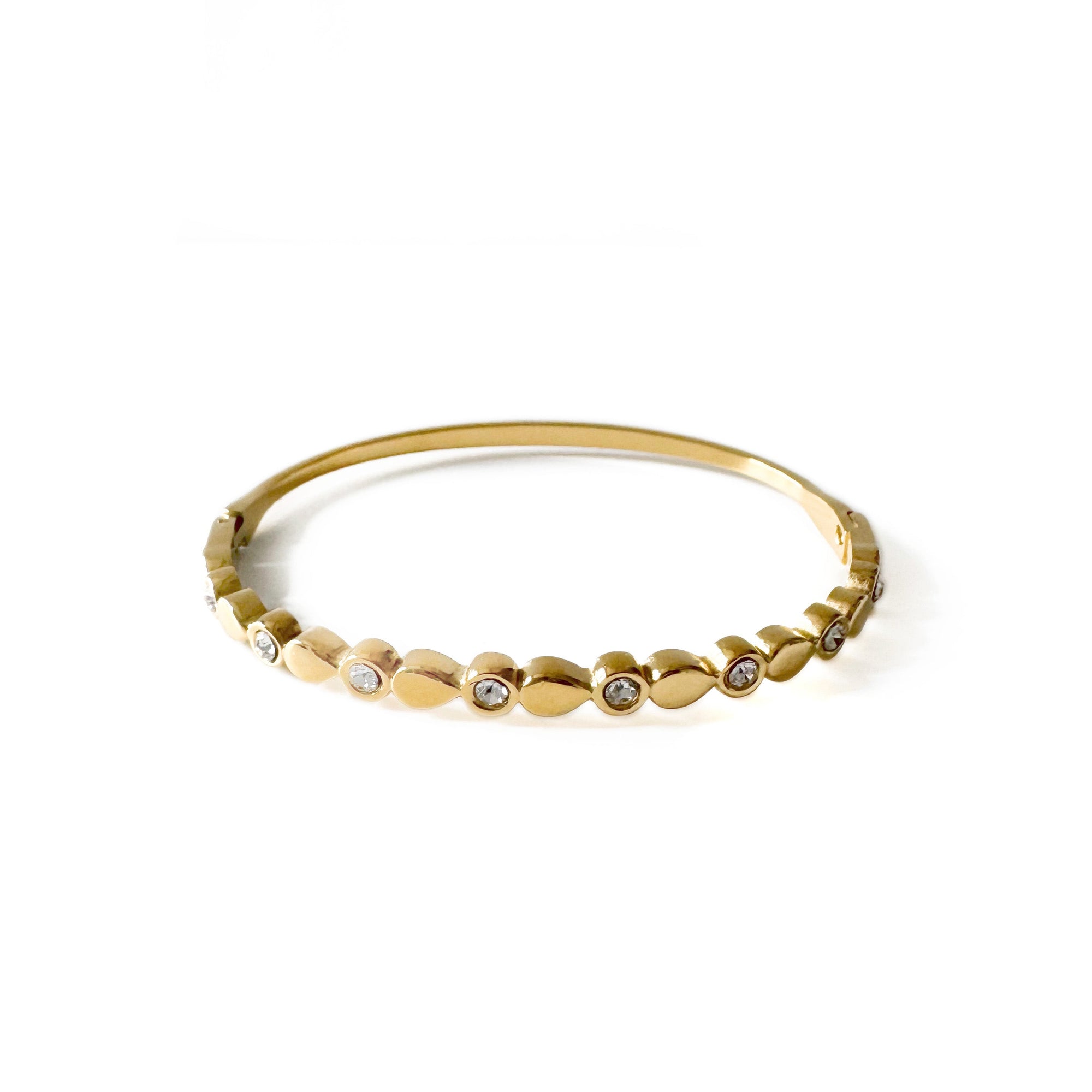 Gold bracelet with small diamonds on a white background