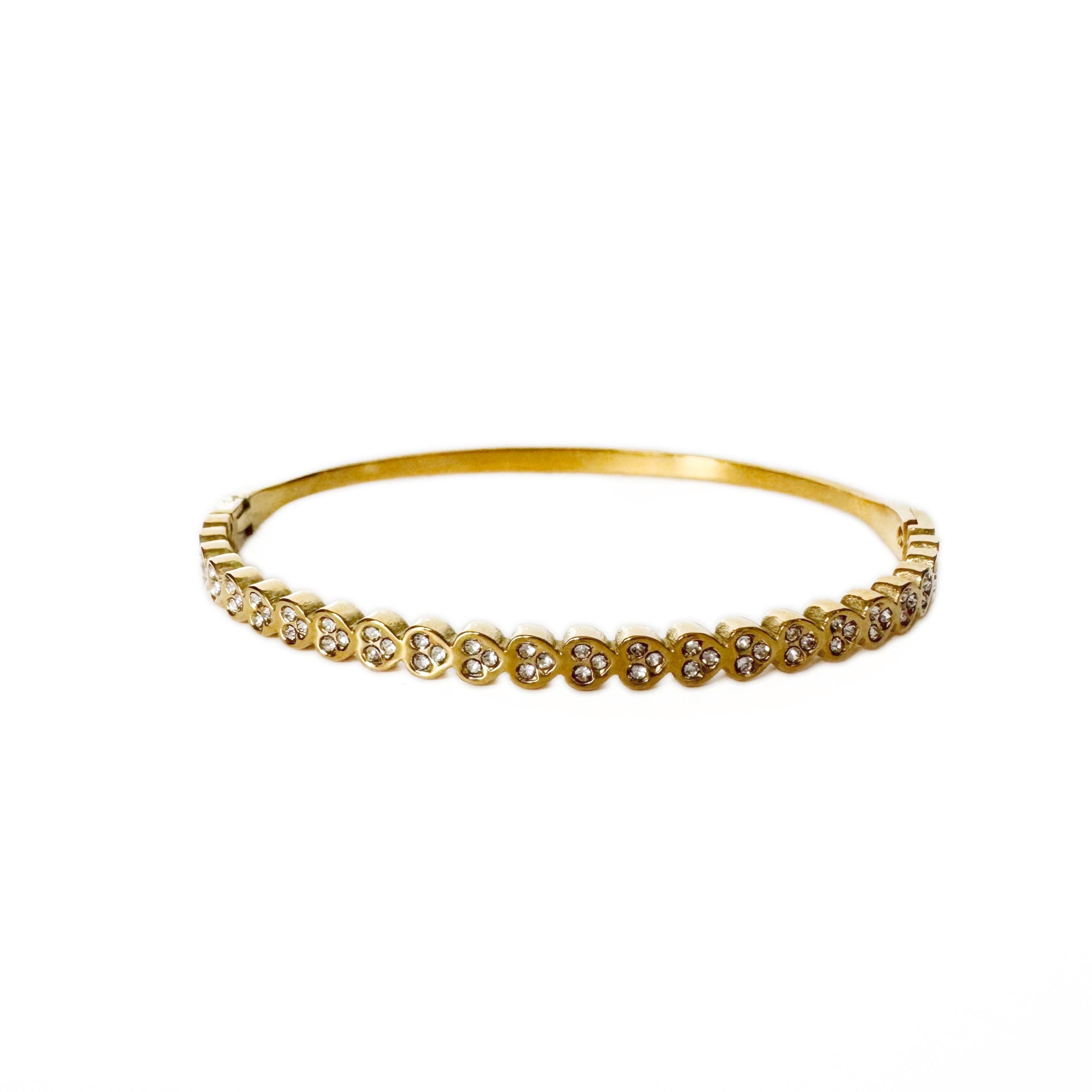 Gold bracelet with small diamonds on a white background